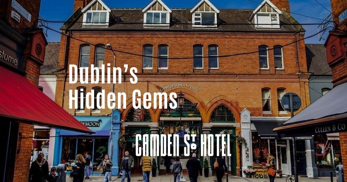 Charming Dublin street, Camden St. Hotel entrance, vibrant shops, relaxed guests strolling, inviting urban experience.